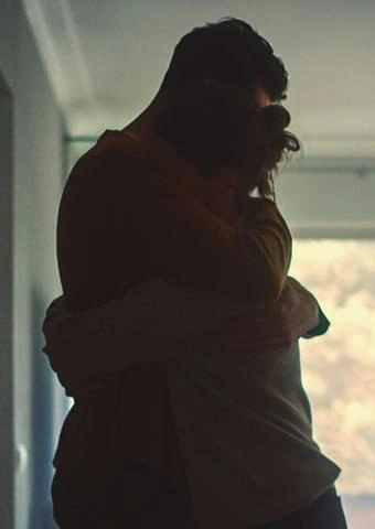Couple embracing warmly at home, reconnecting